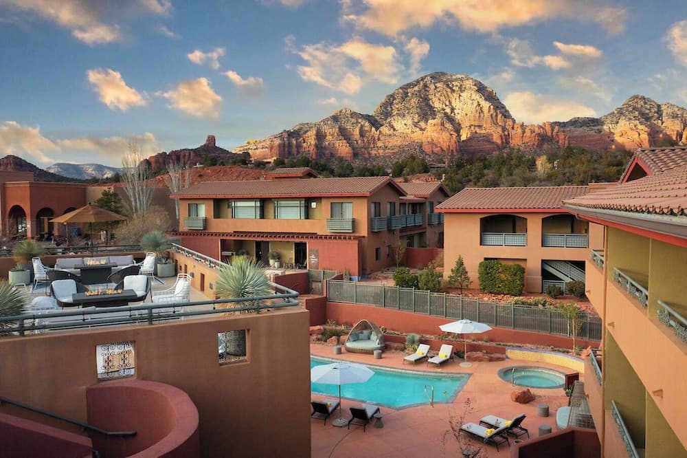The Wilde Resort and Spa pool courtyard with Sedona red rock formations behind the buildings.